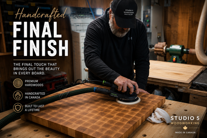 John wearing a black cap and black long-sleeve shirt sanding a large wooden cutting board in a woodworking shop. Large text on the left reads 'Handcrafted FINAL FINISH' with feature callouts, and 'STUDIO 5 WOODWORKING MADE IN CANADA' appears in the lower right.