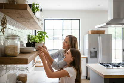 Mother teaching daughter to arrange herbs on thick oak shelves